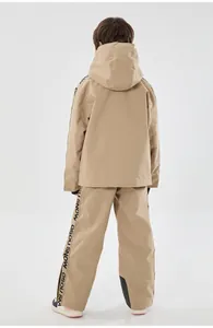 Rear view of kid's khaki ski suit showing waterproof fabric and GSOU SNOW branding