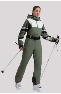 Detail view of professional one-piece ski suit with olive green geometric patchwork design