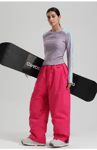 Detail of loose fit waterproof ski pants with zip pockets and adjustable drawstring waist