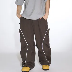 Men's brown waterproof cargo ski pants with white wavy reflective stripes and side pockets