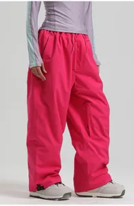 Detail view of pink waterproof ski pants featuring adjustable waist drawstring and side pocket
