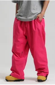 Detail view of bright pink waterproof ski pants featuring cargo pockets and adjustable cuffs