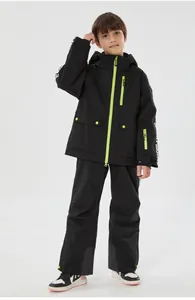 Close-up of kids black ski suit featuring neon green zippers and waterproof fabric