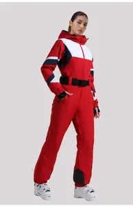 Detail of red one-piece ski suit with geometric color blocks and adjustable waist belt