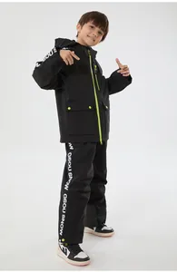 Detail of children's black ski suit showing green zippers and white logo branding