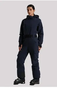 Detail of navy blue one-piece ski suit with adjustable black waist belt and windproof pockets