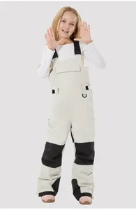 Close-up of kids waterproof ski bibs showing adjustable straps and reinforced knee pads