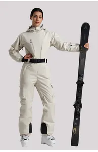 Detail view of cream-colored one-piece ski suit with black belt and waterproof fabric
