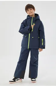 Detail of waterproof kids ski suit with neon green zippers and functional pockets