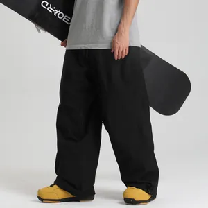Waterproof loose fit black ski pants with wide leg and adjustable drawstring hem for winter