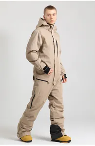 Detail of waterproof beige one-piece ski suit with cargo pockets and windproof zippers