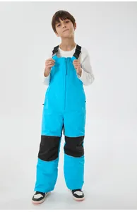 Dettagli dei pantaloni da sci blu per bambini con bretelle e rinforzi sulle ginocchia