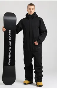 Detail of black one-piece ski suit featuring waterproof zippers and adjustable waist belt