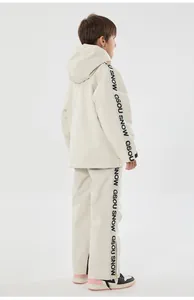 Kids off-white insulated ski suit set featuring waterproof fabric and black side stripes