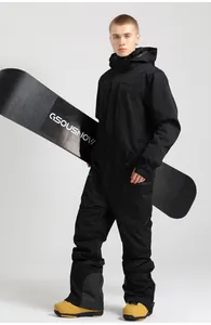 Detailed view of black one-piece ski suit with waterproof zippers and yellow ski boots