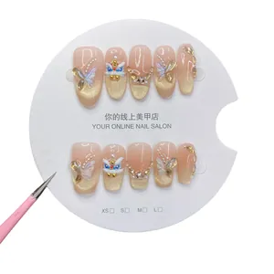 Handmade press-on nails with golden lion dance motif, pink cat eye finish, and 3D butterfly deco