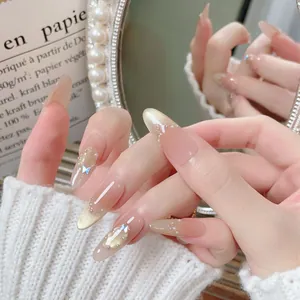 Handmade almond press-on nails with golden cat-eye effect, pearls, and butterfly charms