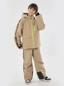 Kids thermal ski suit in sand yellow featuring waterproof hooded jacket and trousers