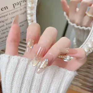 Handmade gradient press-on nails with champagne gold glitter and butterfly nail art stickers