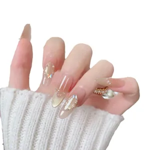 Long almond press-on nails with nude pink gradient, cat eye effect and pearl accents