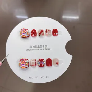 Handmade Chinese New Year lion dance press-on nails in red and white with 3D art