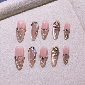 Handmade champagne gold cat-eye press-on nails with diamonds and pearls, oval shape