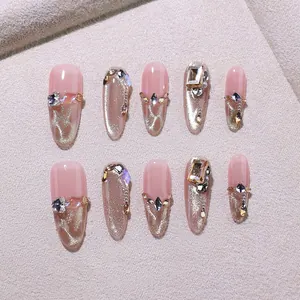 Luxurious handmade press-on nails in champagne gold cat-eye style with crystal rhinestones