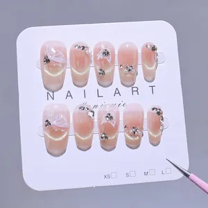 Handmade cat-eye press-on nails with 3D white butterfly and glitter pearls design