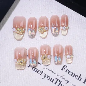 Handmade gradient blush press-on nails with 3D floral accents, pearls and silver glitter