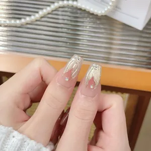 Elegant long ballerina press-on nails in nude pink with golden mermaid tail glitter