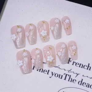 Handmade light pink cat-eye press-on nails with 3D floral relief and glitter detail