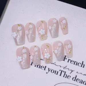 Handmade press-on nails with 3D white flowers, pearls and pink cat-eye shimmer
