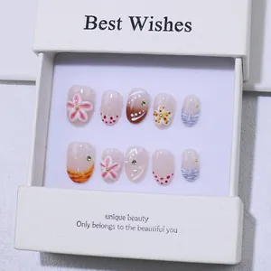 Handmade press-on nails with 3D floral relief and French wave patterns in a gift box