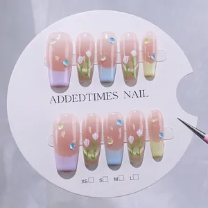 Handmade French press-on nails with pastel macaron tulip patterns and rhinestones