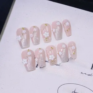 Macro shot of 10pcs handmade press-on nails with 3D white flowers and cat eye effect