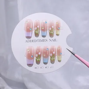 Macro shot of French macaron gradient press-on nails with 3D water droplets and floral art