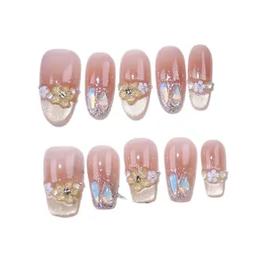 Handmade press-on nails set with pink gradient, 3D floral accents and gold glitter tips
