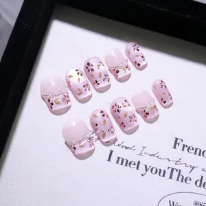 Unghie finte fatte a mano rosa cat eye con perle bianche e decorazioni floreali