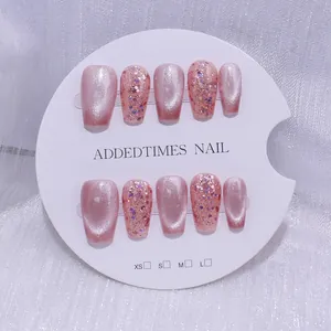 Faux ongles ballerine faits main effet œil de chat rose et paillettes sur tulle blanc