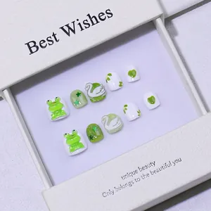 Handmade green and white press-on nails for kids with cute 3D frog and swan designs