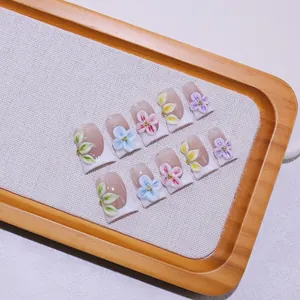 Handmade 3D floral press-on nails with French tips and colorful embossed flower details