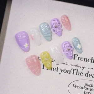 Handmade almond press-on nails with 3D floral reliefs and pearls in pastel colors