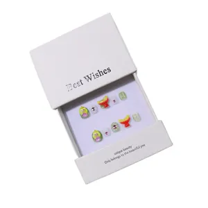 Handmade 10pcs set of kids' press-on nails with cute cartoon girl and fruit art in a white box