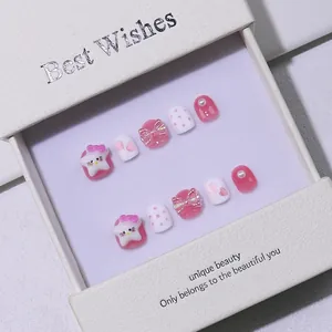 Handmade cute pink and white cartoon press-on nails with 3D bows in a gift box