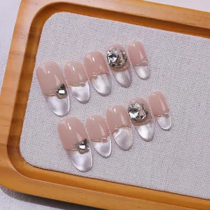 Handmade almond press-on nails with French cat-eye design, rhinestones and bow accents