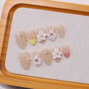 Handmade almond press-on nails with 3D floral carvings and ocean shell textures