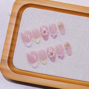 Handmade press-on nails with 3D white flowers, pearls and pink gradient sea shell design