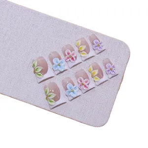 Handmade press-on nails with 3D floral carvings and white French tips in nude pink