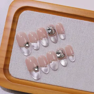 Handmade press-on nails with French cat eye effect and luxury rhinestone butterfly charms
