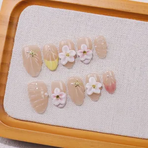 Handmade almond press-on nails with 3D floral, pearl, and seashell patterns for women